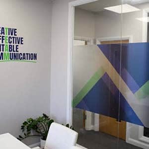 A conference room featuring a glass wall