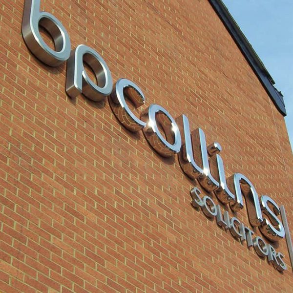 A brick building with a sign "bpcollins".